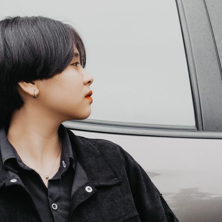 Avery Singh, Lead Design Curator at DomainBoldLedger, reviewing corporate floral arrangements